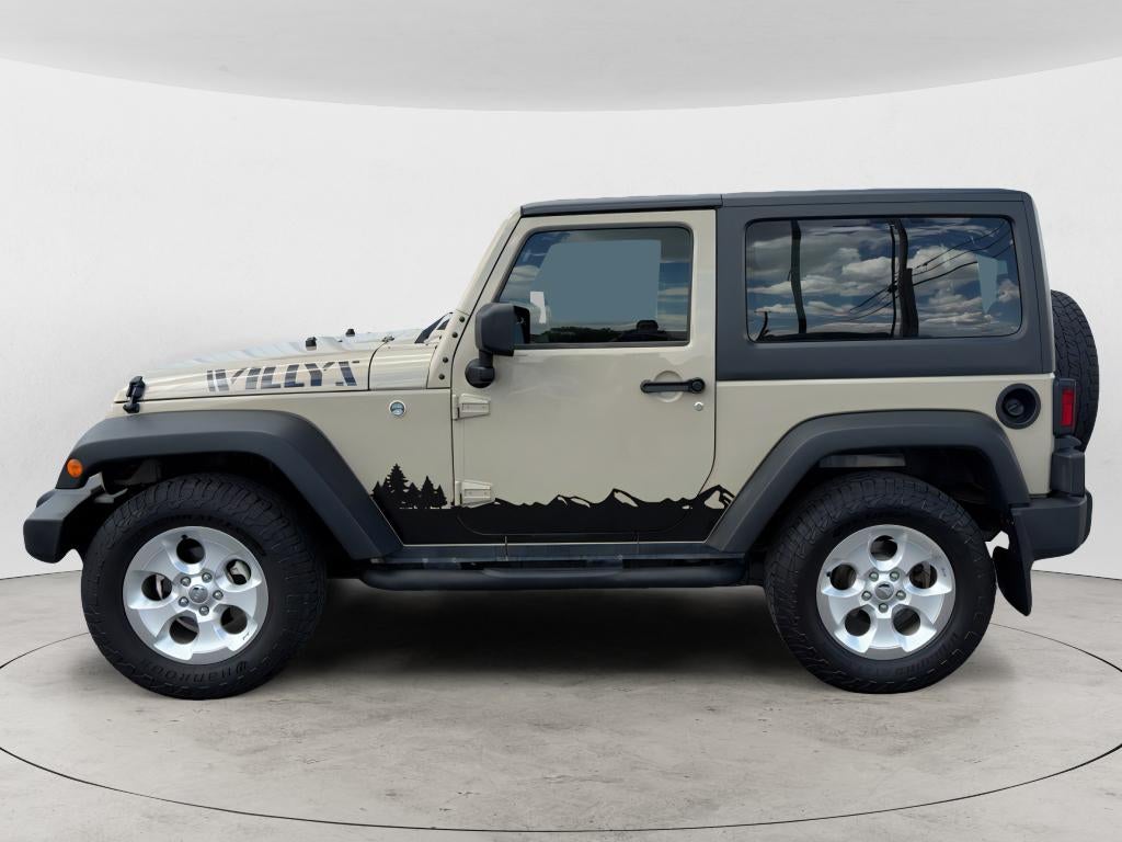 2017 Jeep Wrangler Sport in Champagne — front three-quarter view